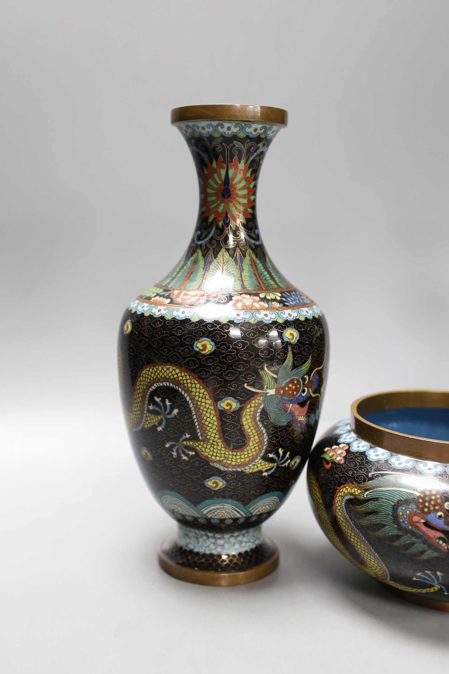 A pair of early 20th century Chinese cloisonne enamel 'dragon' vases and a matching bowl